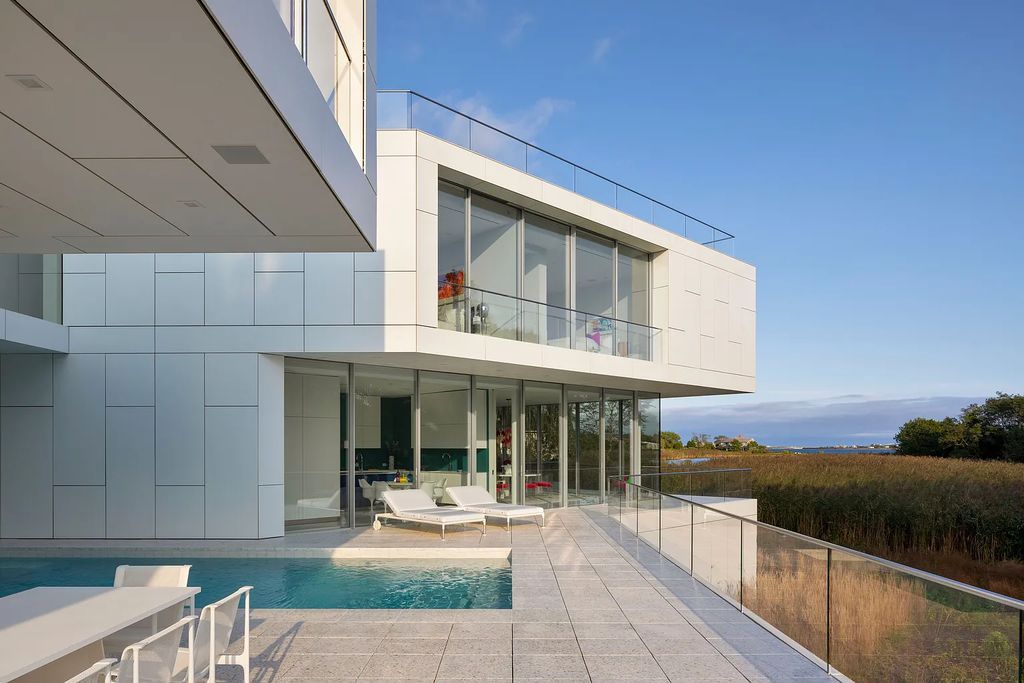 34 Cobb Isle Road, Water Mill, New York is a contemporary architectural masterpiece by renowned architect Roger Ferris overlooking Mecox Bay and the Atlantic Ocean, with 2 docks, plus a fully restored guest house on its own single and separate lot.