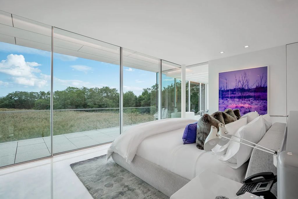 34 Cobb Isle Road, Water Mill, New York is a contemporary architectural masterpiece by renowned architect Roger Ferris overlooking Mecox Bay and the Atlantic Ocean, with 2 docks, plus a fully restored guest house on its own single and separate lot.
