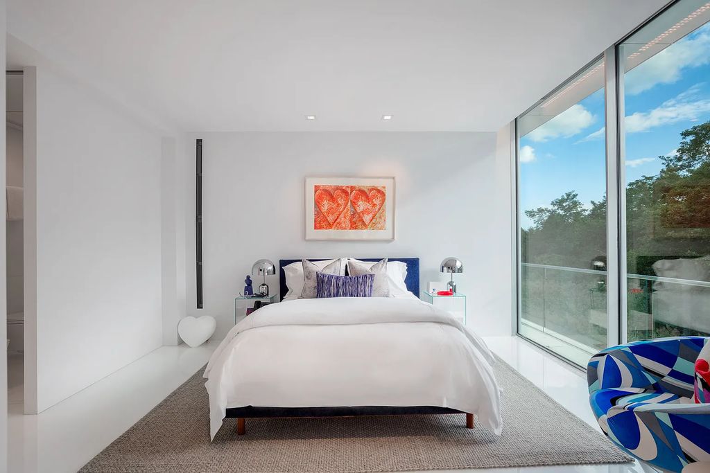 34 Cobb Isle Road, Water Mill, New York is a contemporary architectural masterpiece by renowned architect Roger Ferris overlooking Mecox Bay and the Atlantic Ocean, with 2 docks, plus a fully restored guest house on its own single and separate lot.