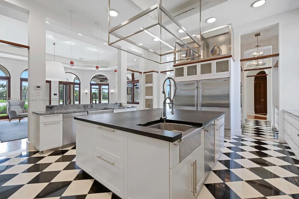 8808 Twin Lake Drive, Boca Raton, Florida is a classic Mediterranean waterfront estate with modern influences located in exclusive gated community of Long Lake Estates situated on 1.1 acres on the best cul-de-sac point lot with southern exposure and 300 ft of waterfrontage.