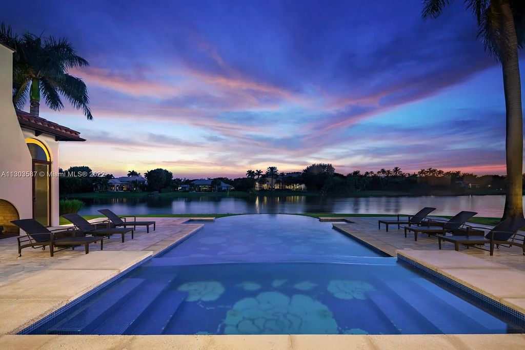 8808 Twin Lake Drive, Boca Raton, Florida is a classic Mediterranean waterfront estate with modern influences located in exclusive gated community of Long Lake Estates situated on 1.1 acres on the best cul-de-sac point lot with southern exposure and 300 ft of waterfrontage.