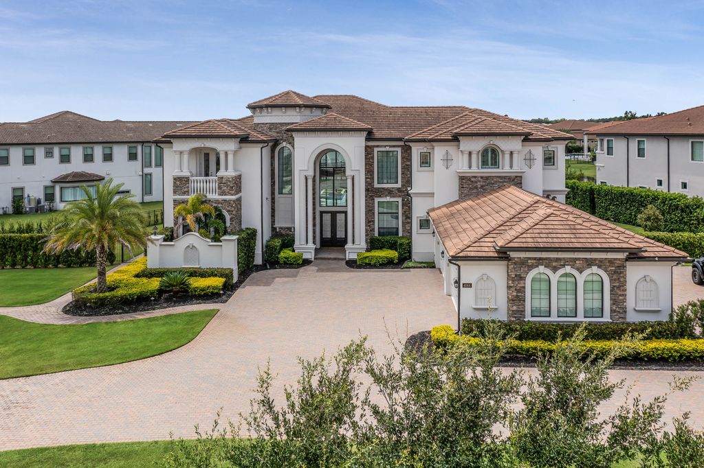 4066 Isabella Circle, Windermere, Florida is a spectacular home with beautiful porcelain floors, high-end appliances, accent wall, expensive light features, and an amazing backyard and gorgeous views.