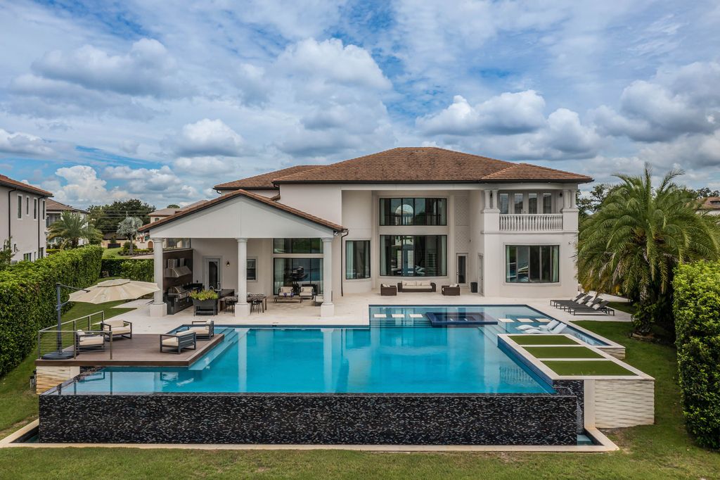 4066 Isabella Circle, Windermere, Florida is a spectacular home with beautiful porcelain floors, high-end appliances, accent wall, expensive light features, and an amazing backyard and gorgeous views.