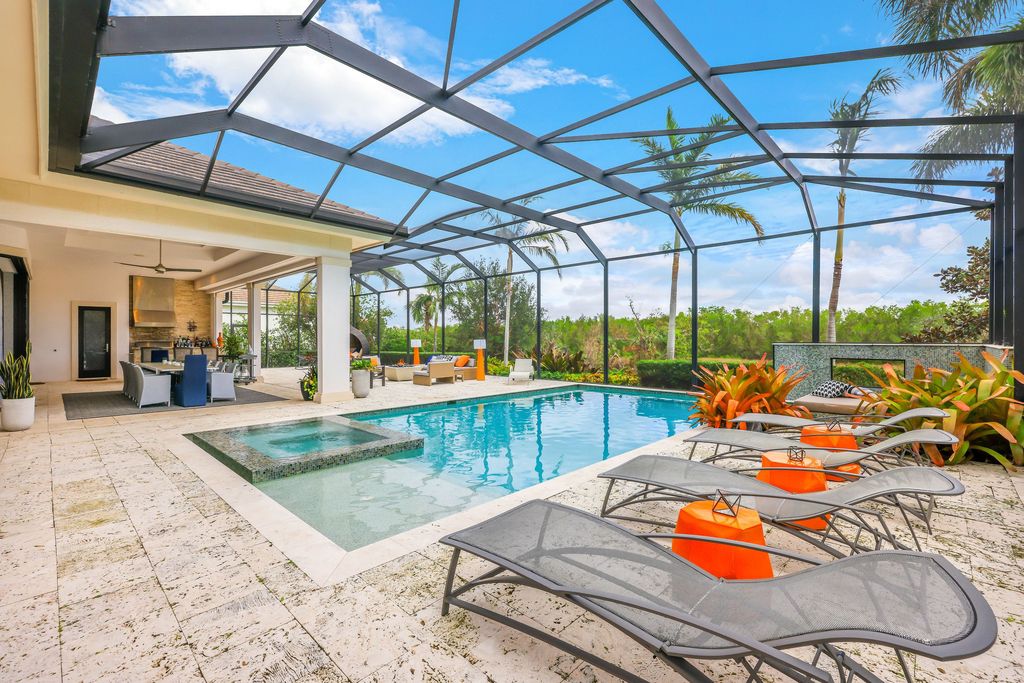 26171 Woodlyn Drive, Bonita Springs, Florida is a contemporary masterpiece with every detail considered for style and comfort, Luxury features include honed porcelain tile, whitewashed oak flooring, state of the art kitchen, stunning wet bar & fireplace, outdoor kitchen, custom pool, outdoor fireplace, and much more.