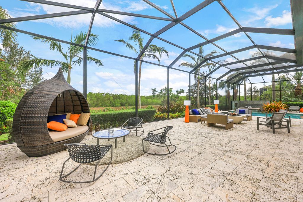 26171 Woodlyn Drive, Bonita Springs, Florida is a contemporary masterpiece with every detail considered for style and comfort, Luxury features include honed porcelain tile, whitewashed oak flooring, state of the art kitchen, stunning wet bar & fireplace, outdoor kitchen, custom pool, outdoor fireplace, and much more.