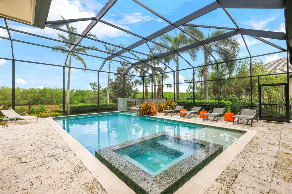 26171 Woodlyn Drive, Bonita Springs, Florida is a contemporary masterpiece with every detail considered for style and comfort, Luxury features include honed porcelain tile, whitewashed oak flooring, state of the art kitchen, stunning wet bar & fireplace, outdoor kitchen, custom pool, outdoor fireplace, and much more.
