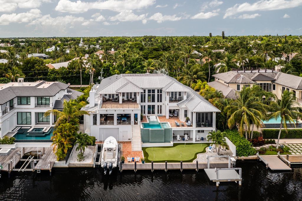 481 21st Ave S, Naples, Florida is a one-of-a-kind estate nestled along the widest canal in Aqualane Shore with hardwood flooring, shiplap siding and outstanding finishes, enhanced by mesmerizing water views.