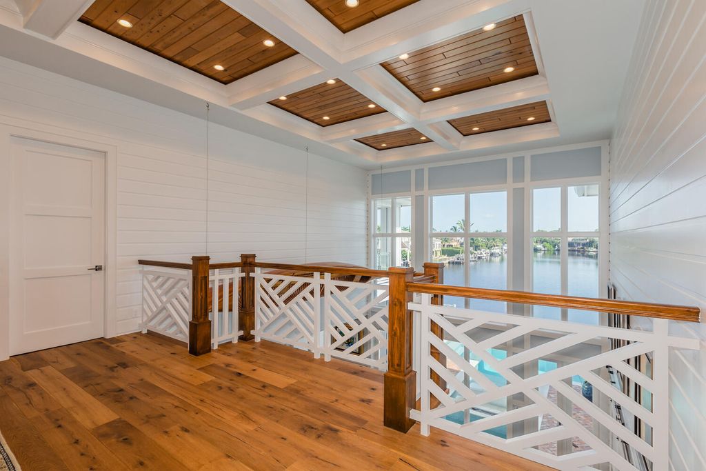 481 21st Ave S, Naples, Florida is a one-of-a-kind estate nestled along the widest canal in Aqualane Shore with hardwood flooring, shiplap siding and outstanding finishes, enhanced by mesmerizing water views.
