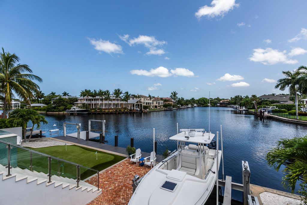 481 21st Ave S, Naples, Florida is a one-of-a-kind estate nestled along the widest canal in Aqualane Shore with hardwood flooring, shiplap siding and outstanding finishes, enhanced by mesmerizing water views.