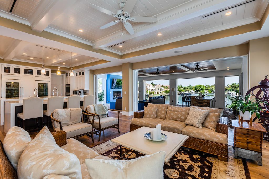 481 21st Ave S, Naples, Florida is a one-of-a-kind estate nestled along the widest canal in Aqualane Shore with hardwood flooring, shiplap siding and outstanding finishes, enhanced by mesmerizing water views.