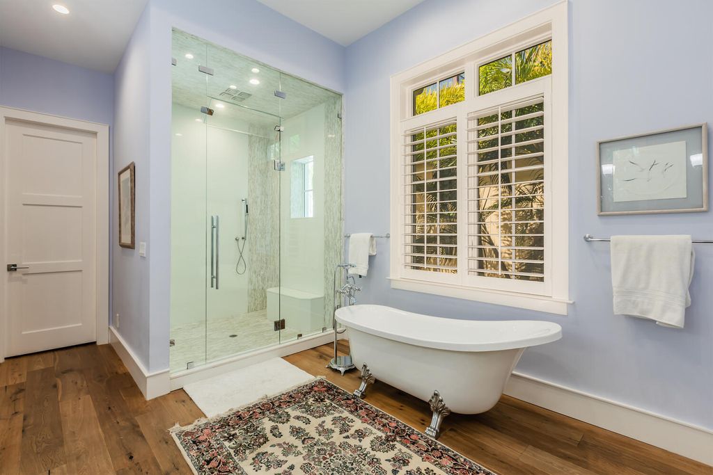 481 21st Ave S, Naples, Florida is a one-of-a-kind estate nestled along the widest canal in Aqualane Shore with hardwood flooring, shiplap siding and outstanding finishes, enhanced by mesmerizing water views.