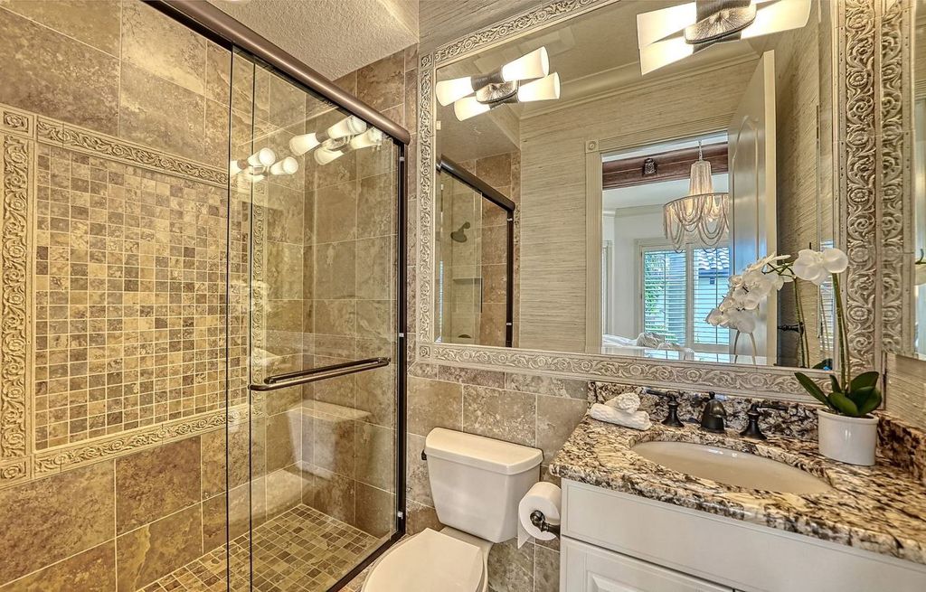 1436 John Ringling Parkway, Sarasota, Florida is a magnificent home in the coveted neighborhood of Lido Shores with impressive architectural details, beautiful chandeliers, custom woodwork, and pristine views of Sarasota Bay.