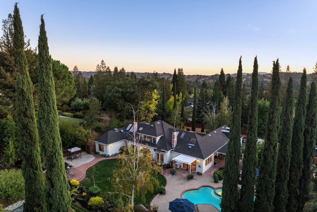 1941 Parkmont Drive, Alamo, California is beautiful remodeled custom home features a resort-like backyard with pool, spa, outdoor kitchen, built-in fire pit, bocce court, expansive level grassy area to play, sport court location, producing vineyard, vegetable garden beds, & fruit trees.