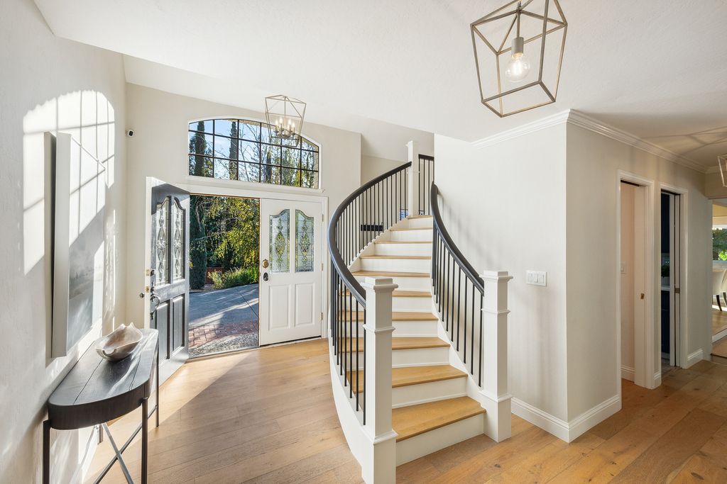 1941 Parkmont Drive, Alamo, California is beautiful remodeled custom home features a resort-like backyard with pool, spa, outdoor kitchen, built-in fire pit, bocce court, expansive level grassy area to play, sport court location, producing vineyard, vegetable garden beds, & fruit trees.