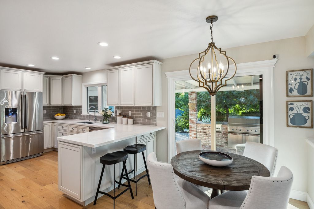 1941 Parkmont Drive, Alamo, California is beautiful remodeled custom home features a resort-like backyard with pool, spa, outdoor kitchen, built-in fire pit, bocce court, expansive level grassy area to play, sport court location, producing vineyard, vegetable garden beds, & fruit trees.