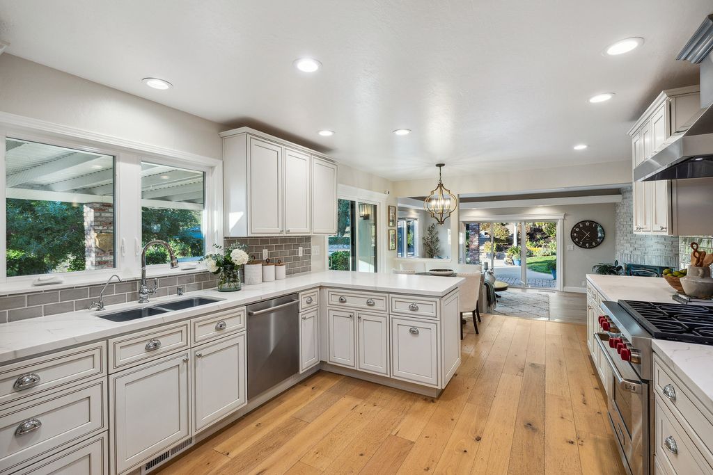 1941 Parkmont Drive, Alamo, California is beautiful remodeled custom home features a resort-like backyard with pool, spa, outdoor kitchen, built-in fire pit, bocce court, expansive level grassy area to play, sport court location, producing vineyard, vegetable garden beds, & fruit trees.