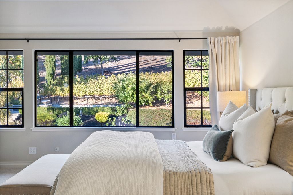 1941 Parkmont Drive, Alamo, California is beautiful remodeled custom home features a resort-like backyard with pool, spa, outdoor kitchen, built-in fire pit, bocce court, expansive level grassy area to play, sport court location, producing vineyard, vegetable garden beds, & fruit trees.