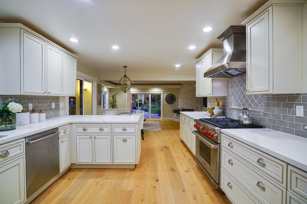 1941 Parkmont Drive, Alamo, California is beautiful remodeled custom home features a resort-like backyard with pool, spa, outdoor kitchen, built-in fire pit, bocce court, expansive level grassy area to play, sport court location, producing vineyard, vegetable garden beds, & fruit trees.