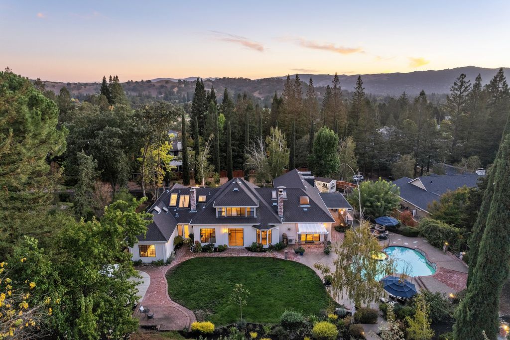 1941 Parkmont Drive, Alamo, California is beautiful remodeled custom home features a resort-like backyard with pool, spa, outdoor kitchen, built-in fire pit, bocce court, expansive level grassy area to play, sport court location, producing vineyard, vegetable garden beds, & fruit trees.