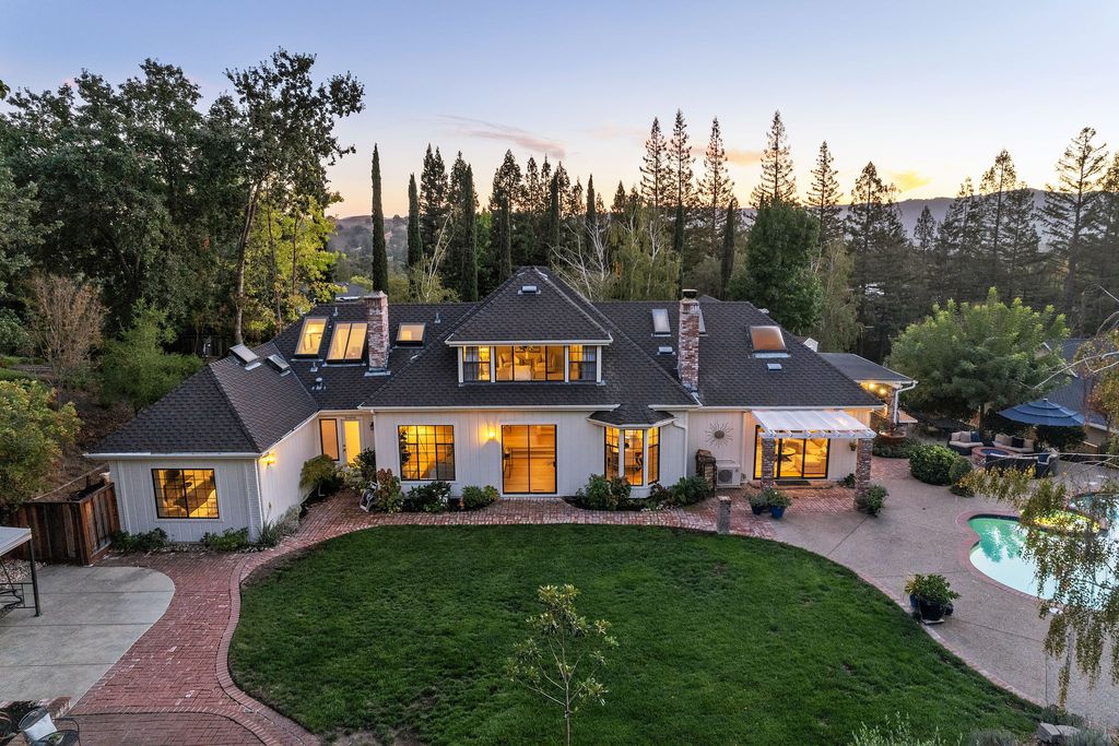 1941 Parkmont Drive, Alamo, California is beautiful remodeled custom home features a resort-like backyard with pool, spa, outdoor kitchen, built-in fire pit, bocce court, expansive level grassy area to play, sport court location, producing vineyard, vegetable garden beds, & fruit trees.