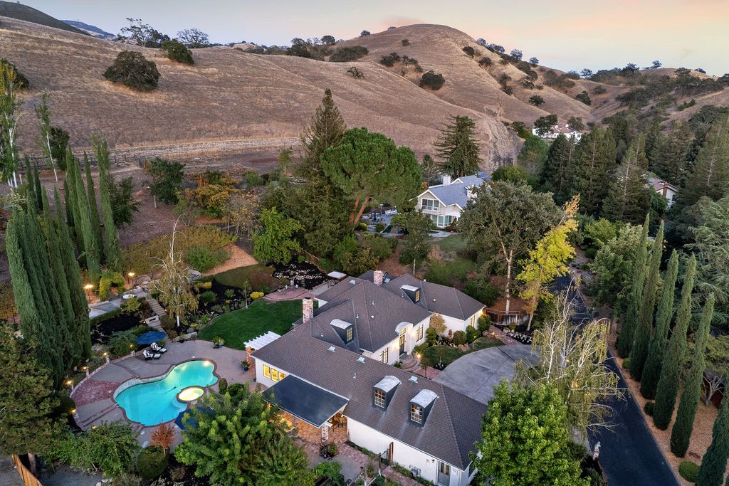 1941 Parkmont Drive, Alamo, California is beautiful remodeled custom home features a resort-like backyard with pool, spa, outdoor kitchen, built-in fire pit, bocce court, expansive level grassy area to play, sport court location, producing vineyard, vegetable garden beds, & fruit trees.