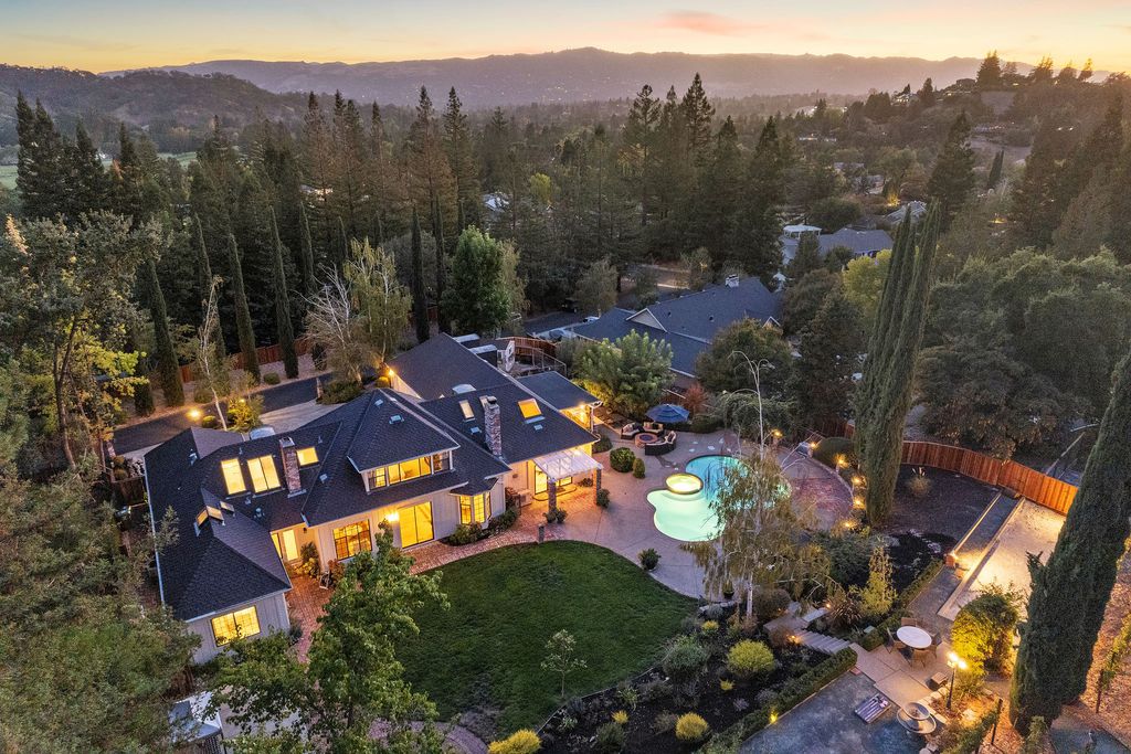 1941 Parkmont Drive, Alamo, California is beautiful remodeled custom home features a resort-like backyard with pool, spa, outdoor kitchen, built-in fire pit, bocce court, expansive level grassy area to play, sport court location, producing vineyard, vegetable garden beds, & fruit trees.