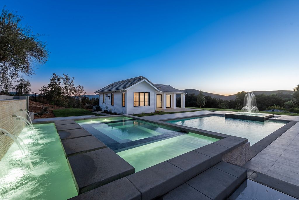 The Home in Thousand Oaks, a special property in the ultra exclusive gated community with extraordinary quality finishes, sensational views and beautiful grounds boasting a custom pool, spa, multiple fountains and lush professional landscape is now available for sale. This home located at 1690 Miller Ranch Dr, Thousand Oaks, California