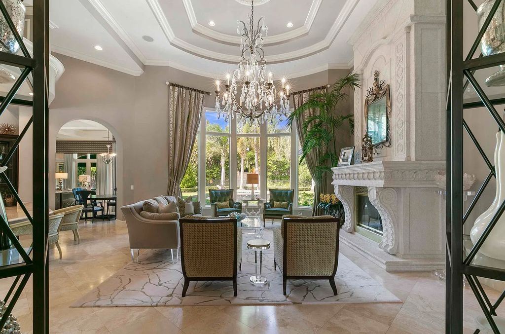 11701 San Sovino Court, Palm Beach Gardens, Florida is a private enclave on one of the most coveted streets within Old Palm Golf Club with tropical water feature view, expansive covered lanai, breezy awnings, heated pool & spa and more.