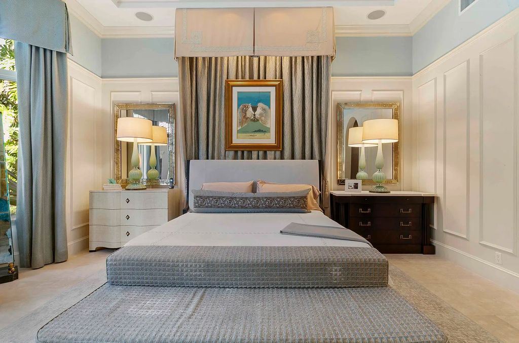11701 San Sovino Court, Palm Beach Gardens, Florida is a private enclave on one of the most coveted streets within Old Palm Golf Club with tropical water feature view, expansive covered lanai, breezy awnings, heated pool & spa and more.