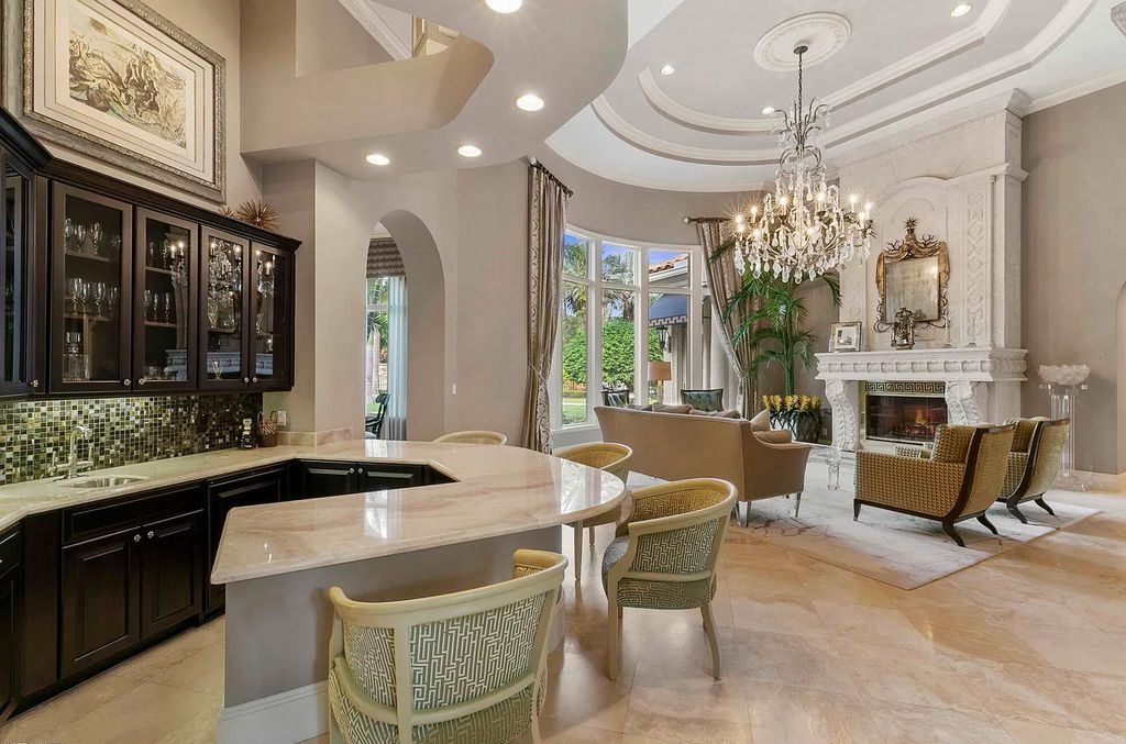 11701 San Sovino Court, Palm Beach Gardens, Florida is a private enclave on one of the most coveted streets within Old Palm Golf Club with tropical water feature view, expansive covered lanai, breezy awnings, heated pool & spa and more.