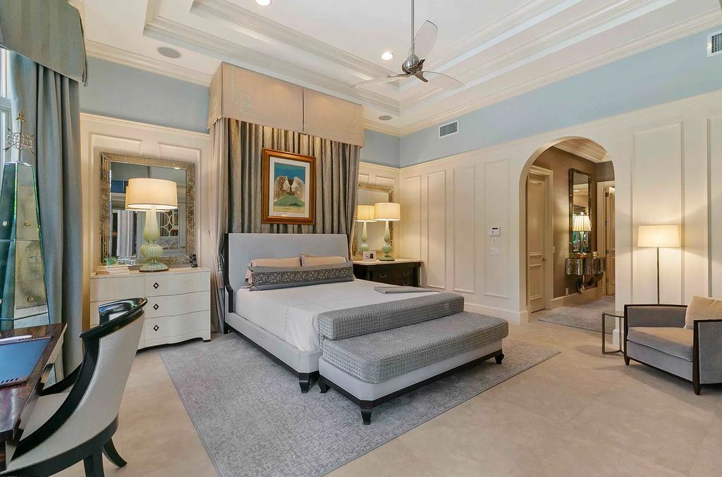11701 San Sovino Court, Palm Beach Gardens, Florida is a private enclave on one of the most coveted streets within Old Palm Golf Club with tropical water feature view, expansive covered lanai, breezy awnings, heated pool & spa and more.