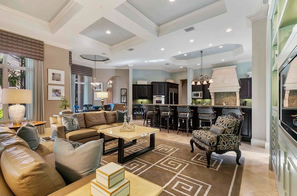 11701 San Sovino Court, Palm Beach Gardens, Florida is a private enclave on one of the most coveted streets within Old Palm Golf Club with tropical water feature view, expansive covered lanai, breezy awnings, heated pool & spa and more.