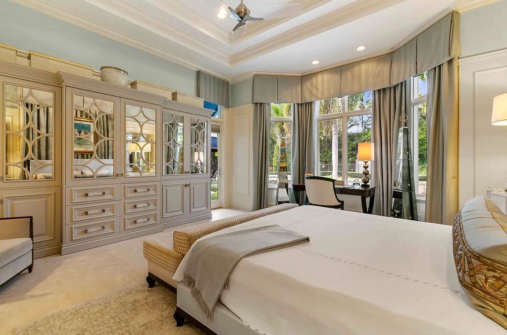 11701 San Sovino Court, Palm Beach Gardens, Florida is a private enclave on one of the most coveted streets within Old Palm Golf Club with tropical water feature view, expansive covered lanai, breezy awnings, heated pool & spa and more.