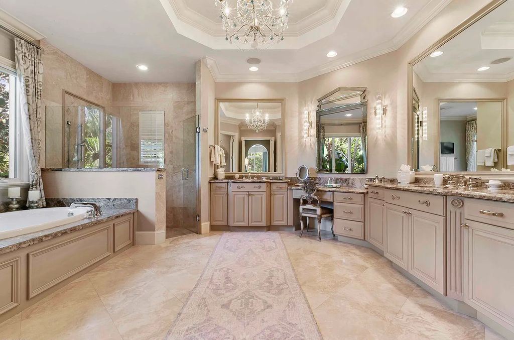 11701 San Sovino Court, Palm Beach Gardens, Florida is a private enclave on one of the most coveted streets within Old Palm Golf Club with tropical water feature view, expansive covered lanai, breezy awnings, heated pool & spa and more.