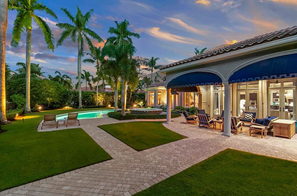 11701 San Sovino Court, Palm Beach Gardens, Florida is a private enclave on one of the most coveted streets within Old Palm Golf Club with tropical water feature view, expansive covered lanai, breezy awnings, heated pool & spa and more.