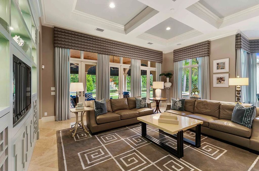 11701 San Sovino Court, Palm Beach Gardens, Florida is a private enclave on one of the most coveted streets within Old Palm Golf Club with tropical water feature view, expansive covered lanai, breezy awnings, heated pool & spa and more.
