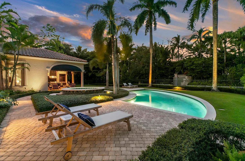 11701 San Sovino Court, Palm Beach Gardens, Florida is a private enclave on one of the most coveted streets within Old Palm Golf Club with tropical water feature view, expansive covered lanai, breezy awnings, heated pool & spa and more.