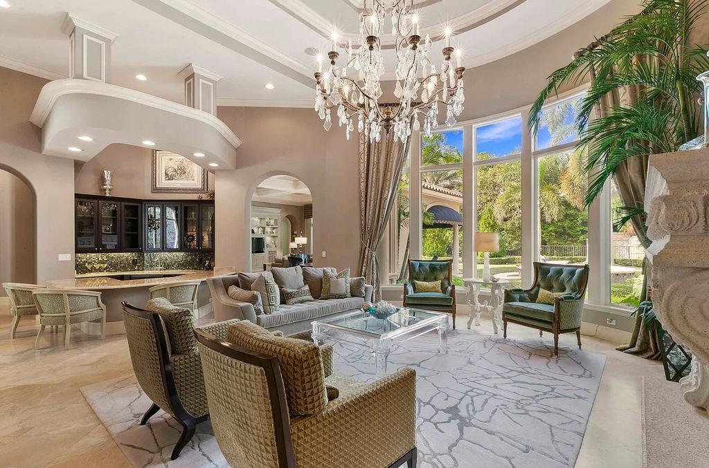 11701 San Sovino Court, Palm Beach Gardens, Florida is a private enclave on one of the most coveted streets within Old Palm Golf Club with tropical water feature view, expansive covered lanai, breezy awnings, heated pool & spa and more.