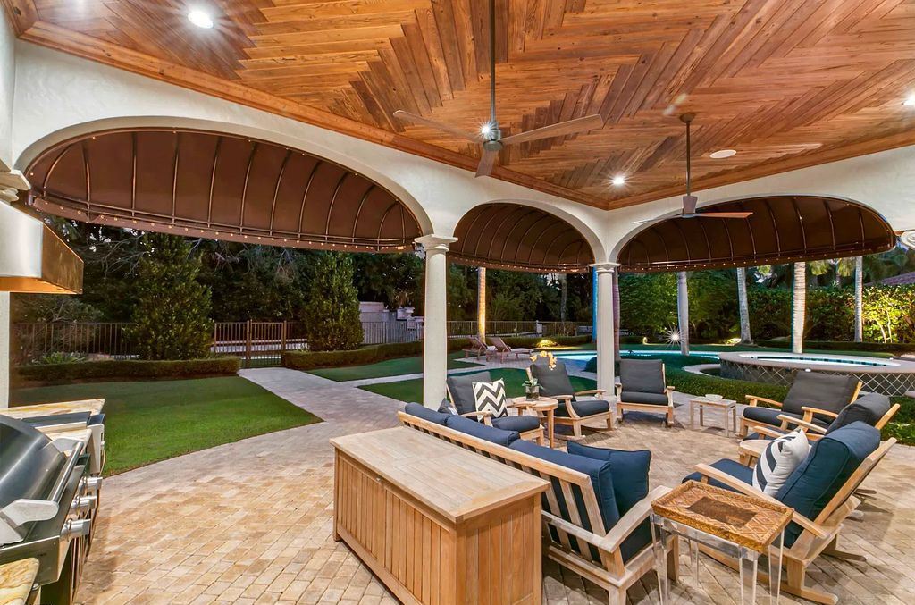 11701 San Sovino Court, Palm Beach Gardens, Florida is a private enclave on one of the most coveted streets within Old Palm Golf Club with tropical water feature view, expansive covered lanai, breezy awnings, heated pool & spa and more.