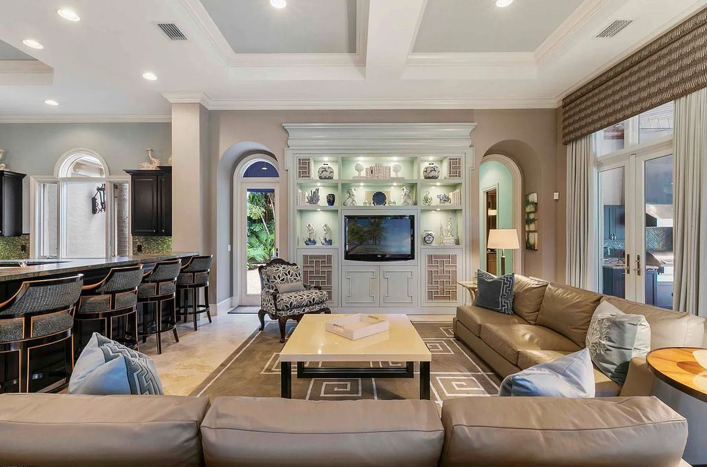 11701 San Sovino Court, Palm Beach Gardens, Florida is a private enclave on one of the most coveted streets within Old Palm Golf Club with tropical water feature view, expansive covered lanai, breezy awnings, heated pool & spa and more.
