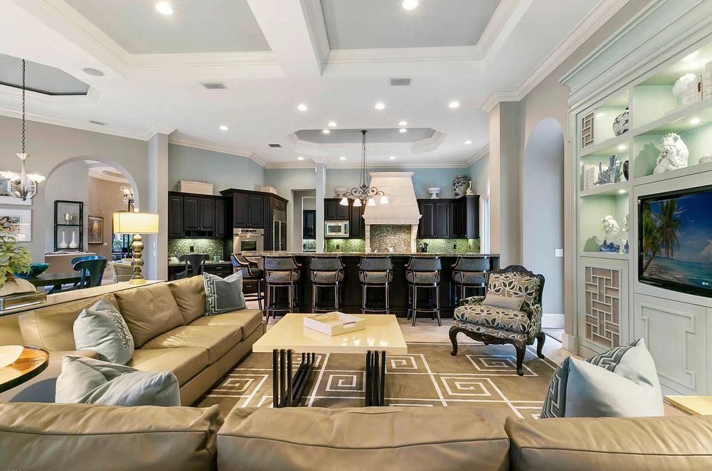 11701 San Sovino Court, Palm Beach Gardens, Florida is a private enclave on one of the most coveted streets within Old Palm Golf Club with tropical water feature view, expansive covered lanai, breezy awnings, heated pool & spa and more.