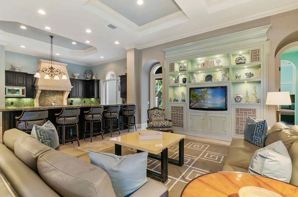 11701 San Sovino Court, Palm Beach Gardens, Florida is a private enclave on one of the most coveted streets within Old Palm Golf Club with tropical water feature view, expansive covered lanai, breezy awnings, heated pool & spa and more.