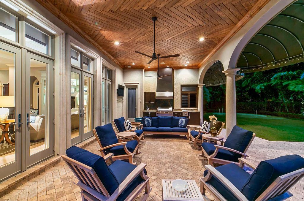 11701 San Sovino Court, Palm Beach Gardens, Florida is a private enclave on one of the most coveted streets within Old Palm Golf Club with tropical water feature view, expansive covered lanai, breezy awnings, heated pool & spa and more.