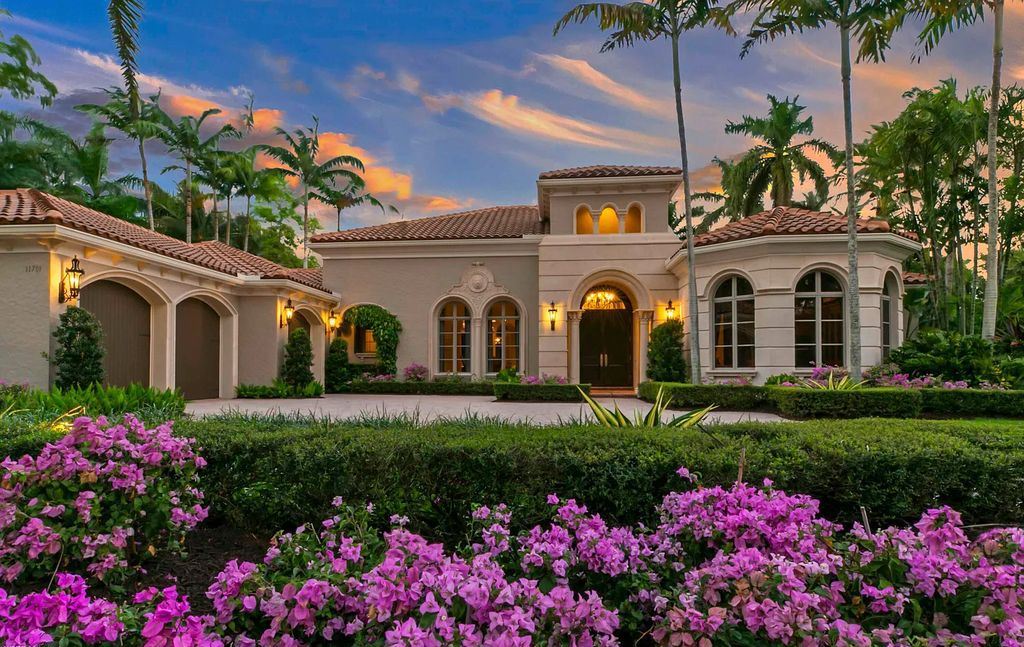 11701 San Sovino Court, Palm Beach Gardens, Florida is a private enclave on one of the most coveted streets within Old Palm Golf Club with tropical water feature view, expansive covered lanai, breezy awnings, heated pool & spa and more.