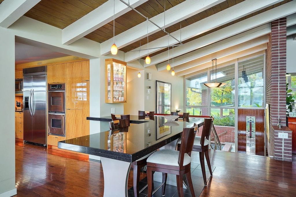The House in Excelsior offers formal dining room along with unique built-in breakfast bar just off the kitchen, now available for sale. This home located at 2605 Maple Ridge Ln, Excelsior, Minnesota