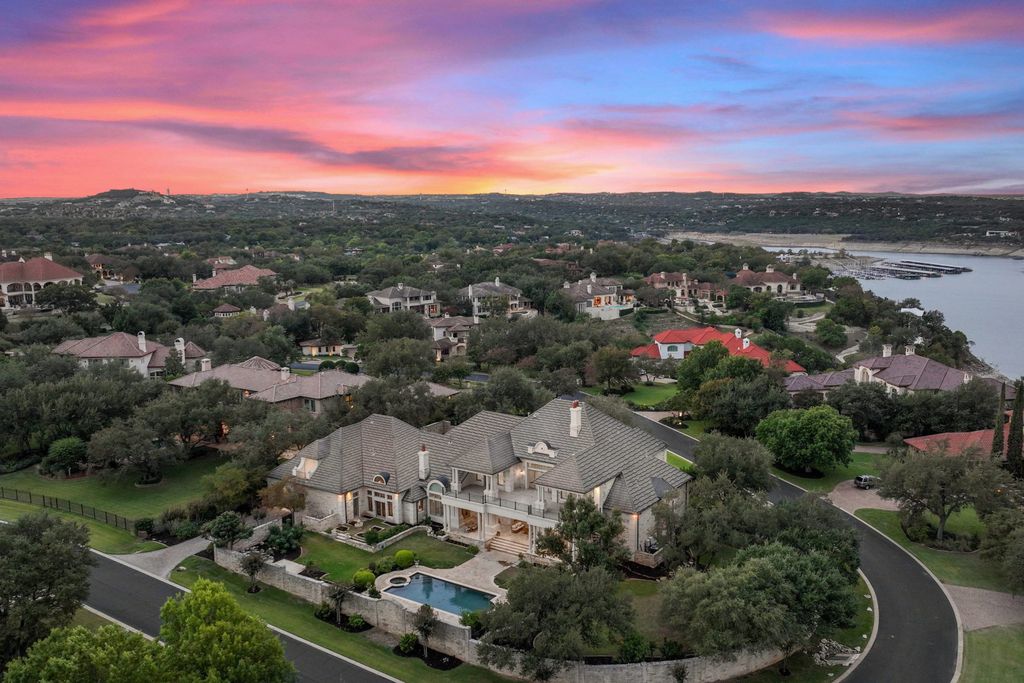208 Bella Riva Drive, Austin, Texas seated on a well-manicured acre lot with complete privacy and lake views in the coveted gated community of Costa Bella on Lake Travis boasting timeless, high-quality craftsmanship abounds in every corner.