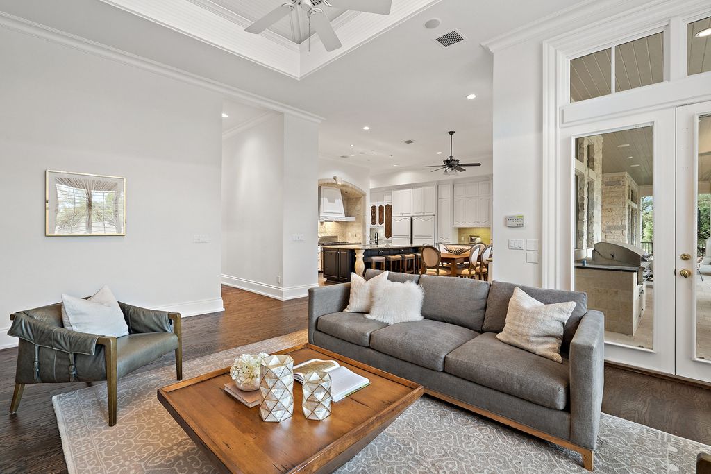 208 Bella Riva Drive, Austin, Texas seated on a well-manicured acre lot with complete privacy and lake views in the coveted gated community of Costa Bella on Lake Travis boasting timeless, high-quality craftsmanship abounds in every corner.