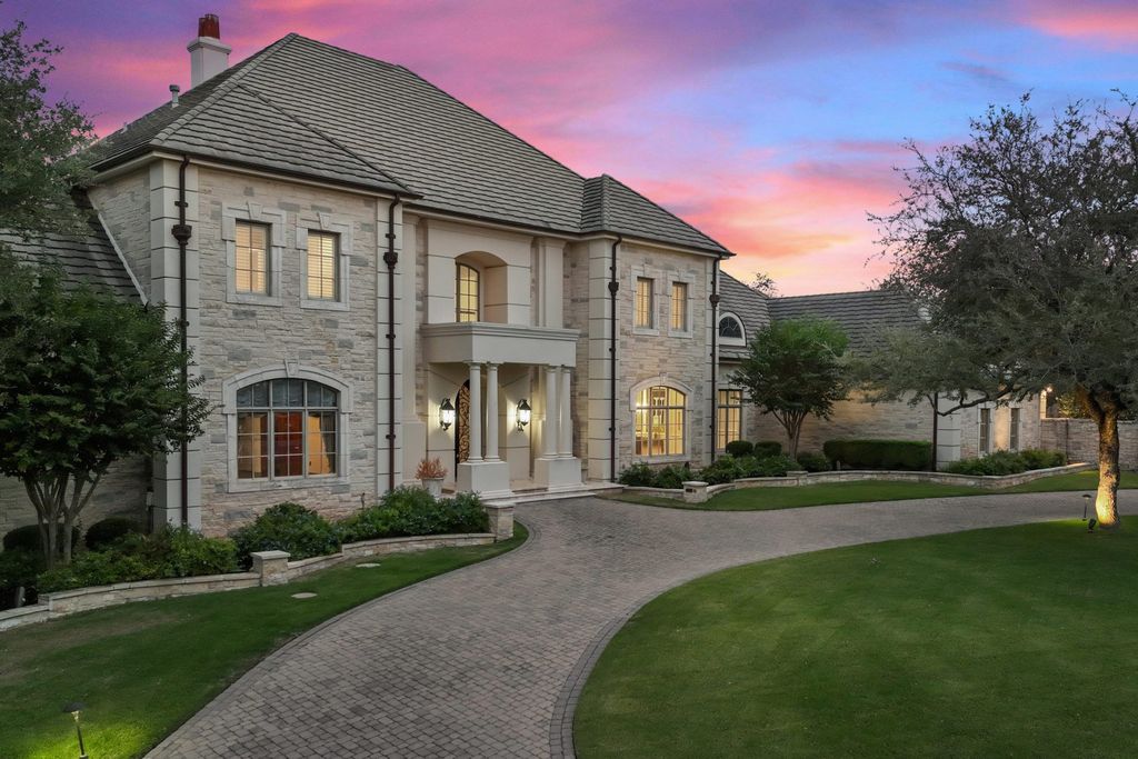208 Bella Riva Drive, Austin, Texas seated on a well-manicured acre lot with complete privacy and lake views in the coveted gated community of Costa Bella on Lake Travis boasting timeless, high-quality craftsmanship abounds in every corner.