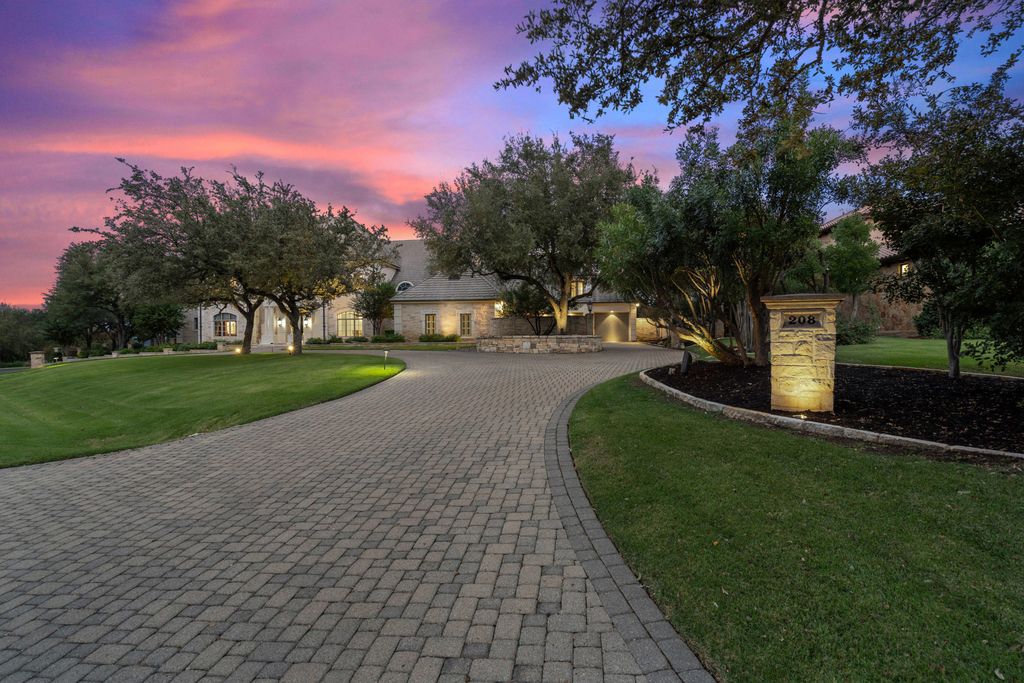 208 Bella Riva Drive, Austin, Texas seated on a well-manicured acre lot with complete privacy and lake views in the coveted gated community of Costa Bella on Lake Travis boasting timeless, high-quality craftsmanship abounds in every corner.