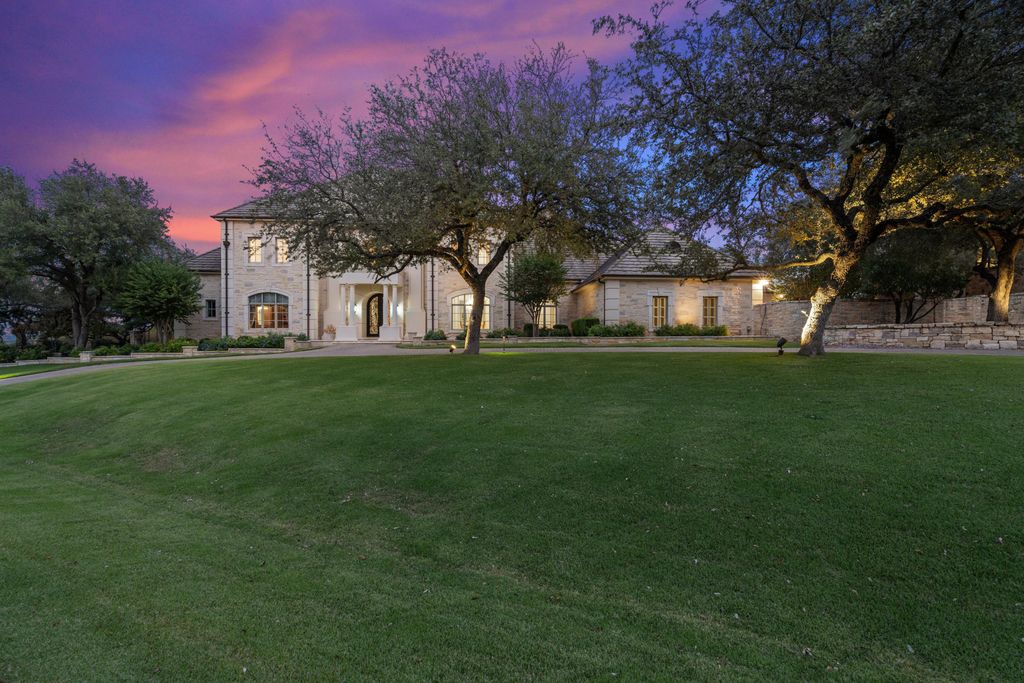 208 Bella Riva Drive, Austin, Texas seated on a well-manicured acre lot with complete privacy and lake views in the coveted gated community of Costa Bella on Lake Travis boasting timeless, high-quality craftsmanship abounds in every corner.